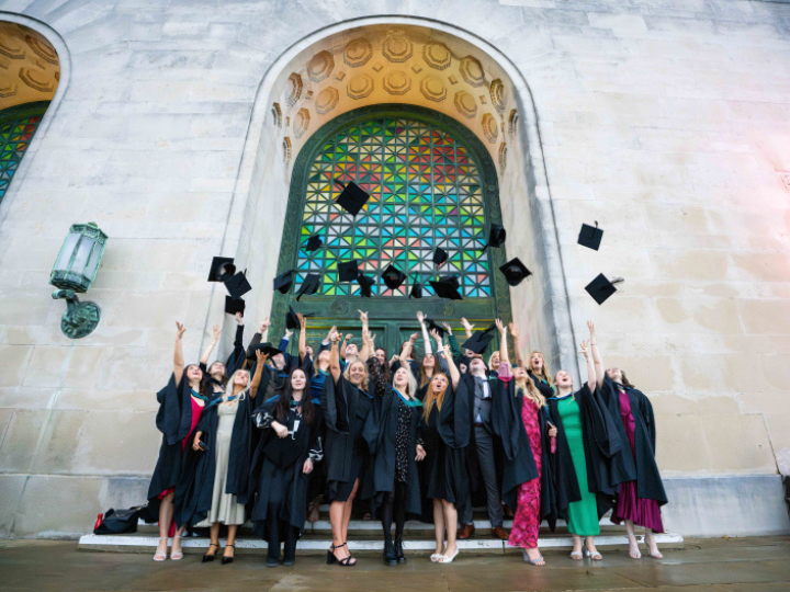 Image of students throwing mortar boards at Swansea Winter Graduation