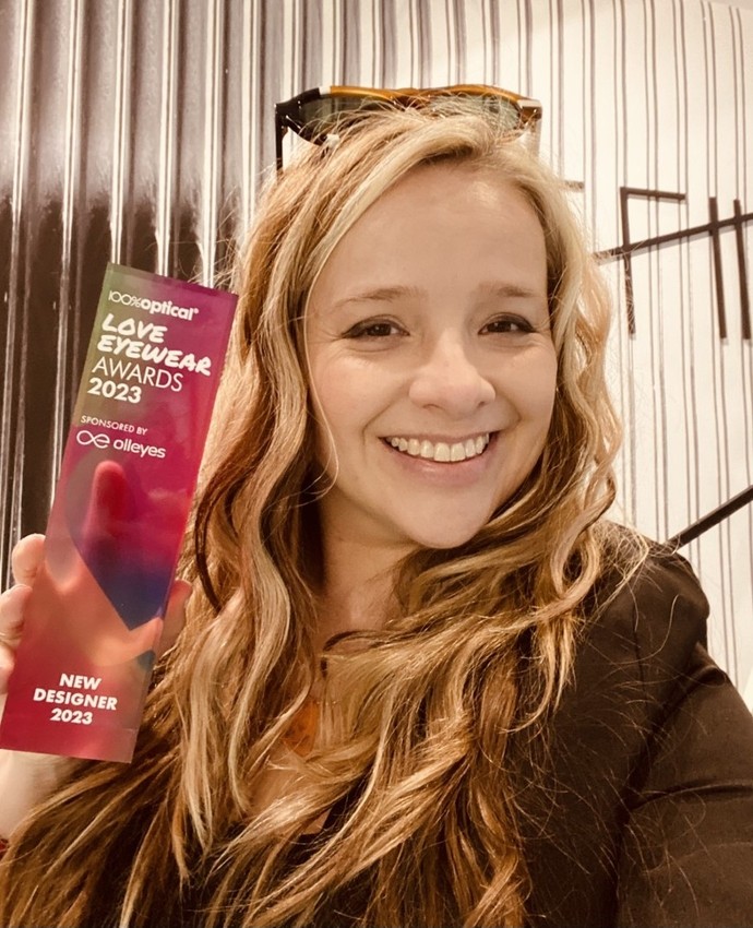 UWTSD Design Crafts lecturer Anna Lewis happily holding her Love Eyewear Award for 'New Designer 2023'.