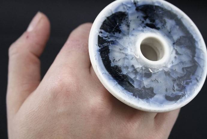 Close up of a big  white and blue ceramic ring designed by Zach Dunlap.