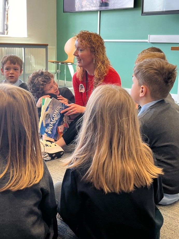 Eluned Grandis, UWTSD lecturer reading a story to Llanddarog School Pupils