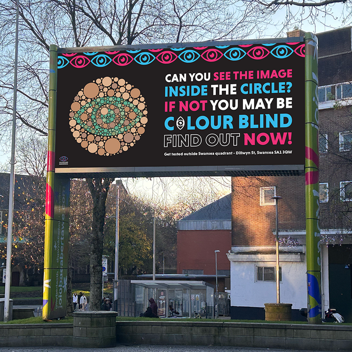Design for a digital billboard to advertise eye testing; text asks: can you see the image inside the circle? If not you may be colour blind – find out now; an image shows the green outline of an eye set inside a circle filled with brown circles of various sizes. 