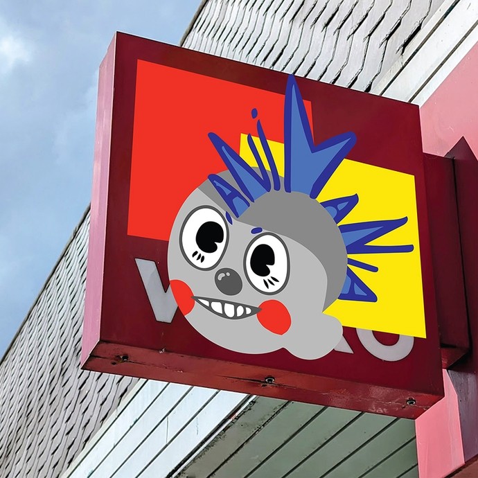 A modern shop sign showing a grey circular cartoon head with a blue spiky cockscomb; an overlapping red and yellow square form the background. 