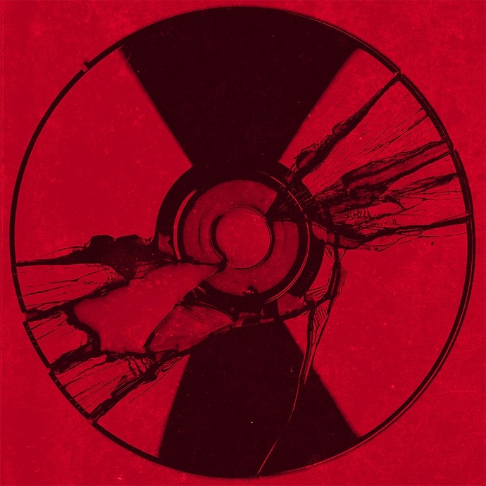 A black CD on a flecked red background; the CD has been torn and scratched; a fragment of the disc is missing. 