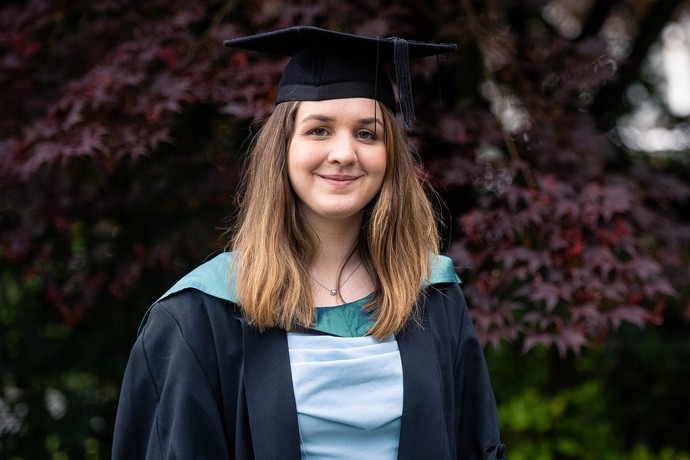 an image of Rhein wearing her cap and gown