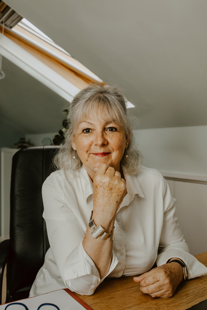 An image of Barbara Scott posing in an office environment
