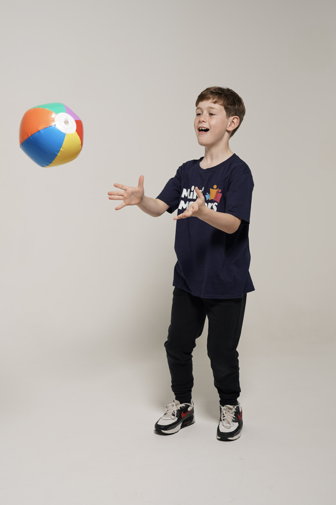 A child catching a ball and playing through the Mini movers app