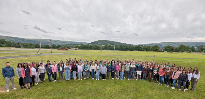 a group photo of all Mentera team members standing in a field