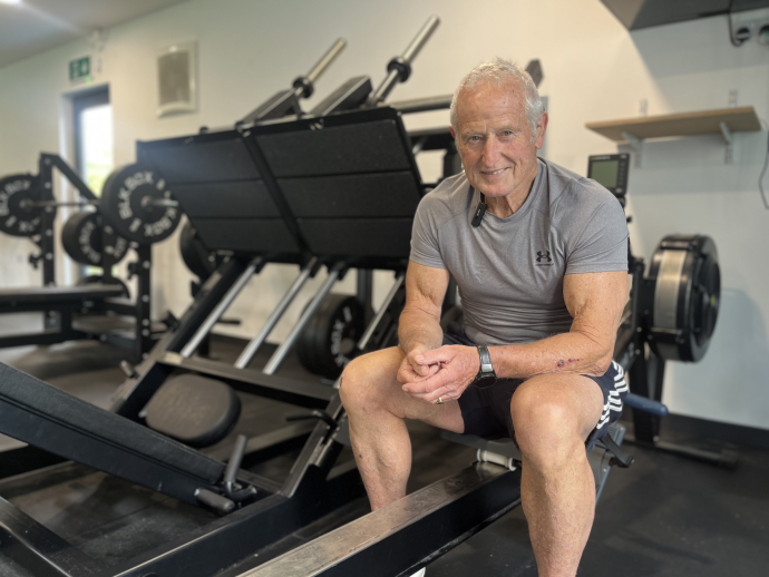 Peter Herbert sitting on a rowing machine