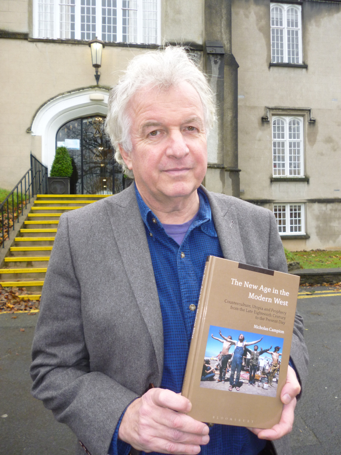 Nick Campion holding his book The New Age in the Modern West: Counterculture, Utopia and Prophecy from the Late Eighteenth Century to the Present Day  on the Lampeter Campus