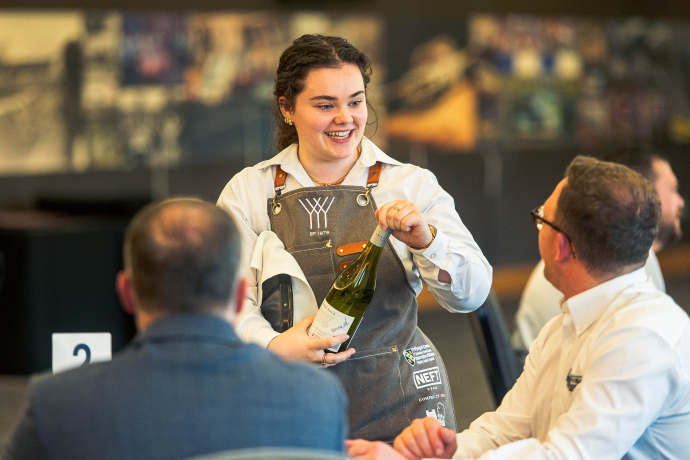 an image of Arwen serving wine 