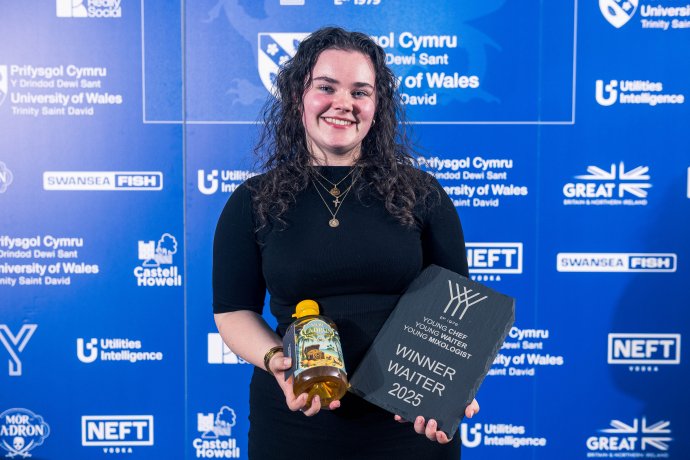 Image of Arwen holding a bottle of rum and trophy