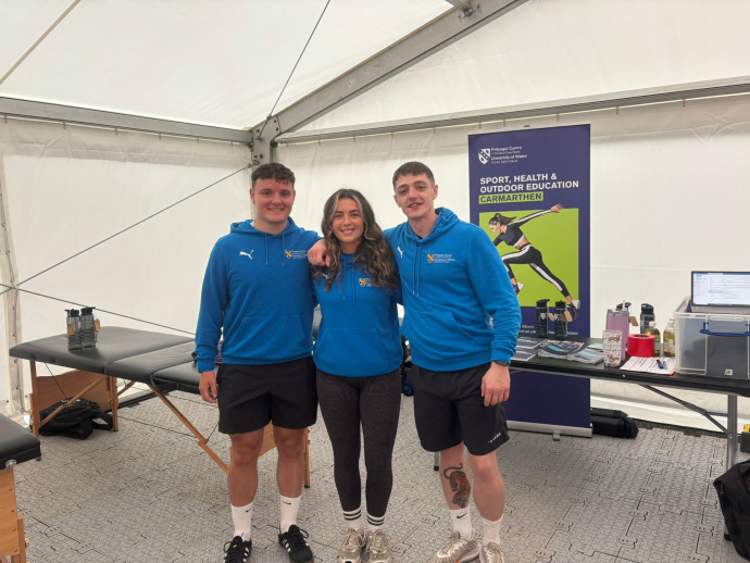 students standing together in a marquee