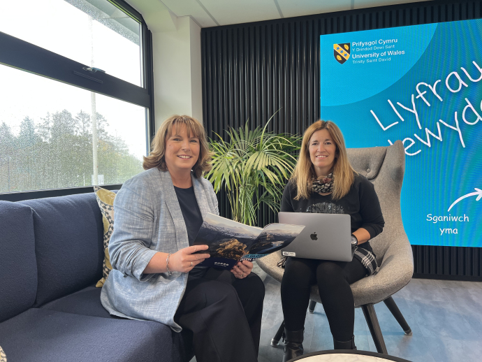 an image of Sarah Loxdale and lowri Harris sitting down 