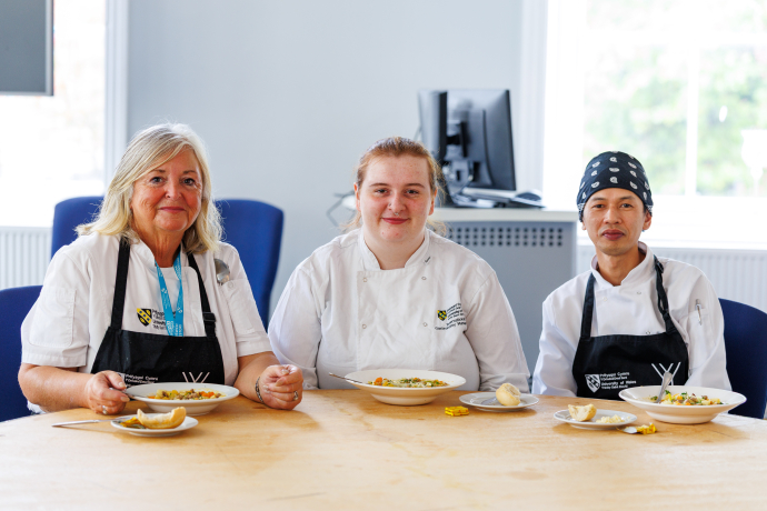 Jayne Griffith Parry and two students sitting together with food in front of them 
