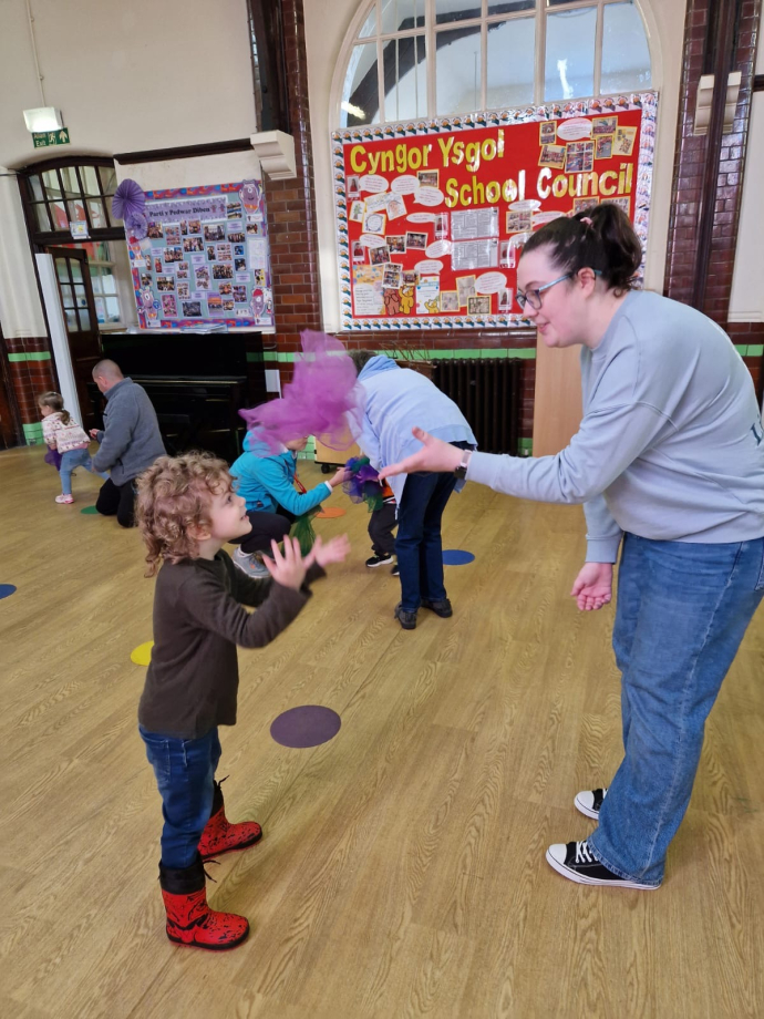 A child and adult playing with scarves