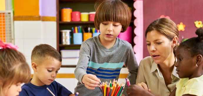 Children sitting in classroom with teacher