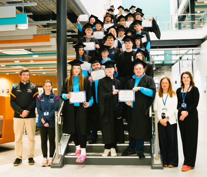 a group shot of the students in their cap and gown 