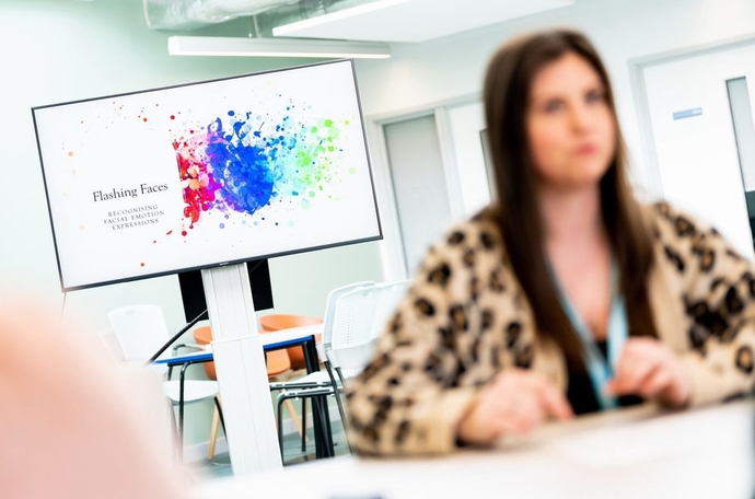 an image of a student blurred sitting in front of a screen