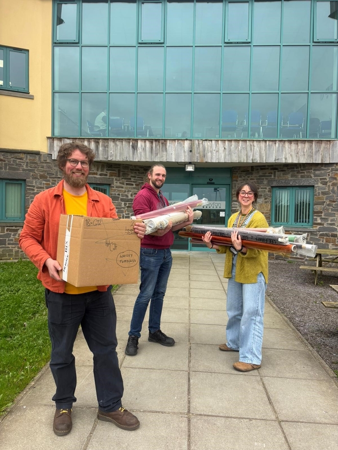 Staff members of the Set Design course holding props that were donated by Tilly