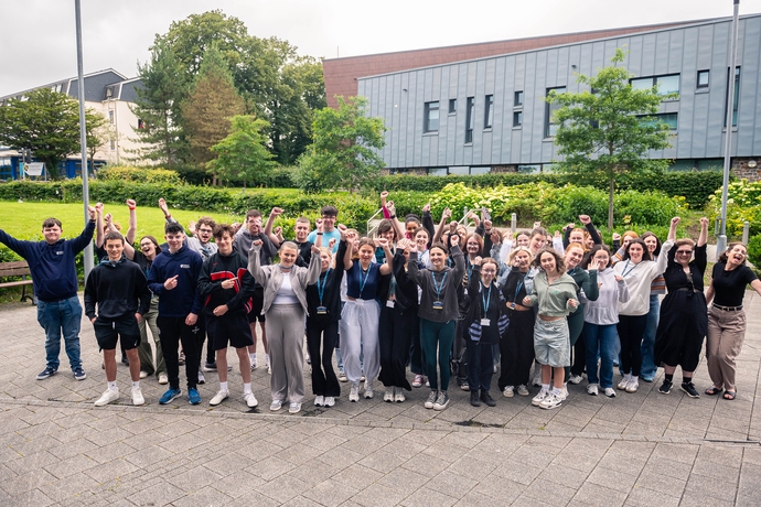 a group of students gathered outside 