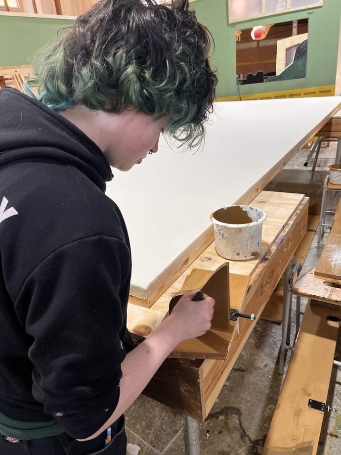 student Felix Roberts preparing the set