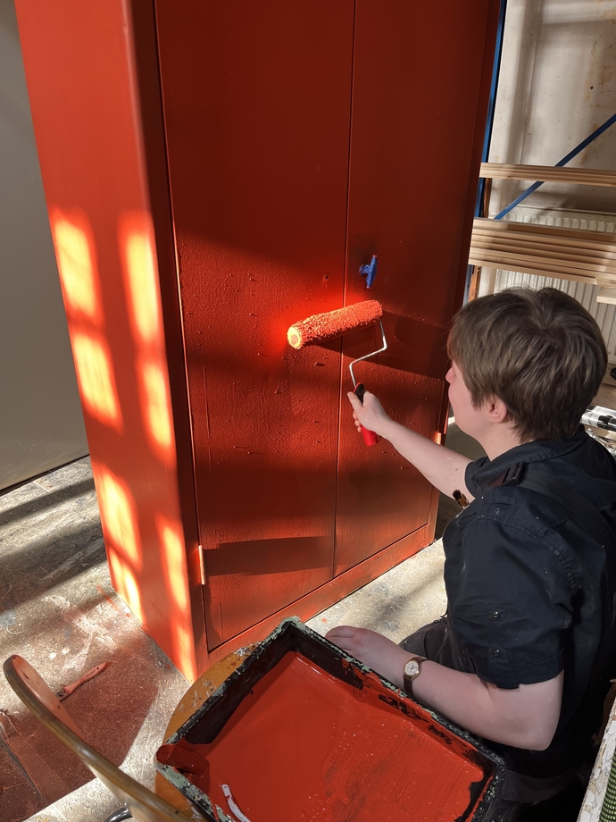 student brushing paint
