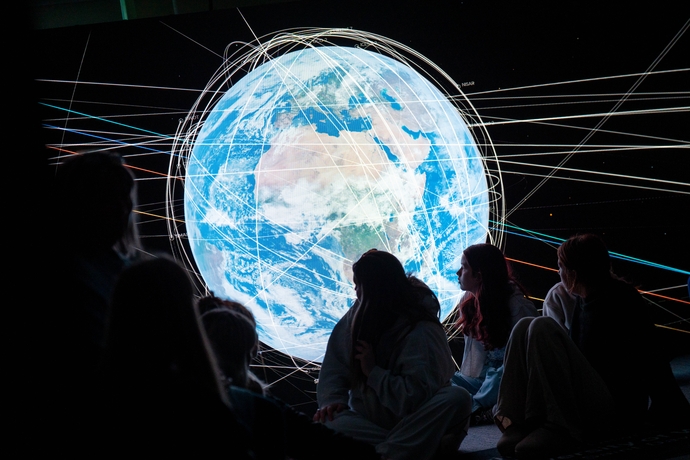 Student looking at an interactive globe