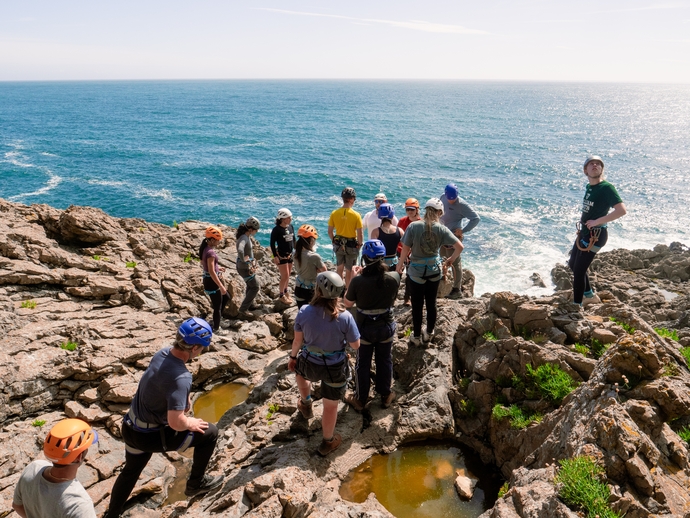 students walking on cliffs around the Gower
