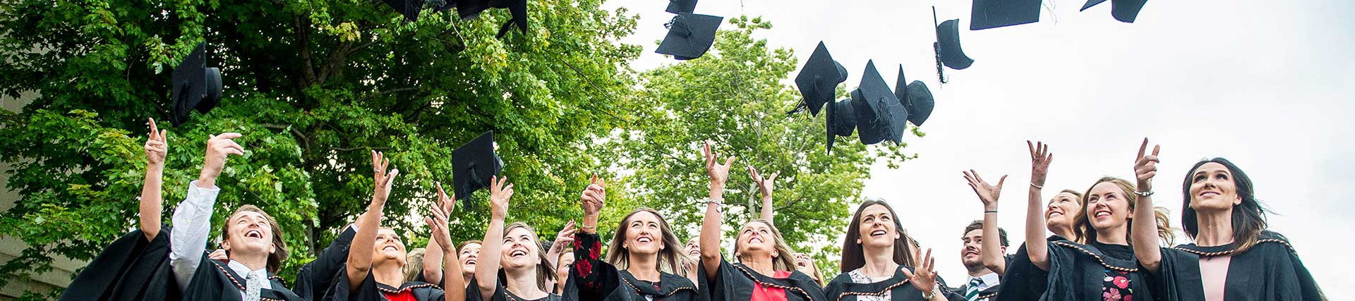 a group of students throwing hats in the air