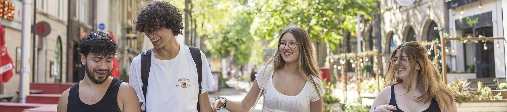 four students walking through swansea town
