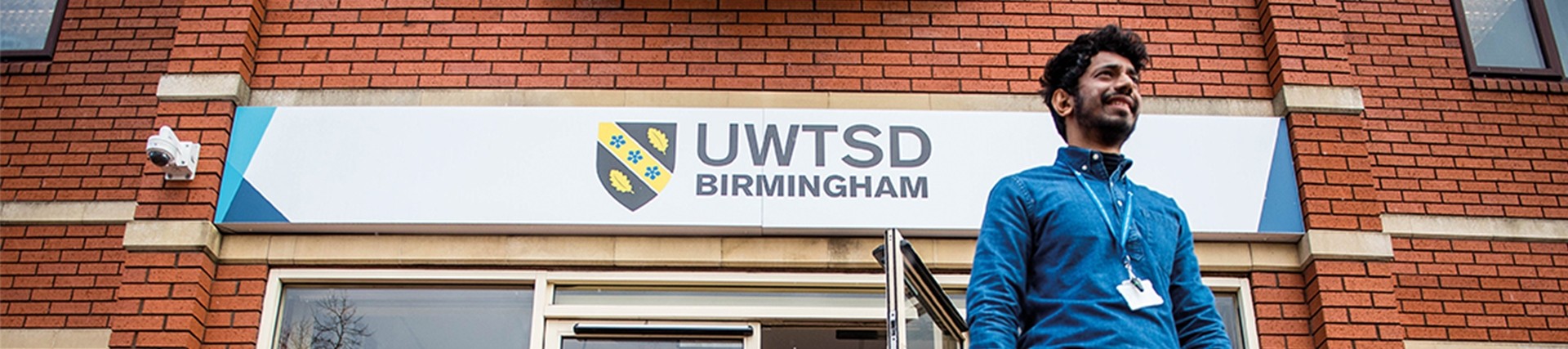 Student walking out from front of Birmingham Campus