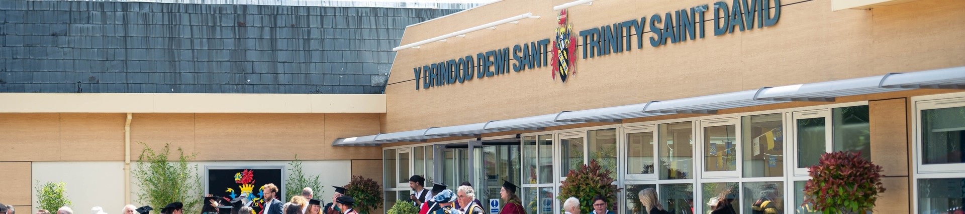 Graduation crowd outside a UWTSD building