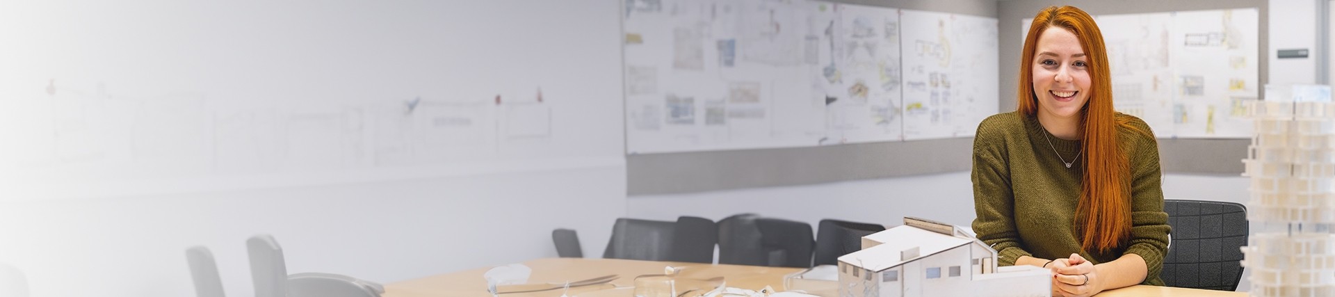 Student sitting in front of a architectural building concept