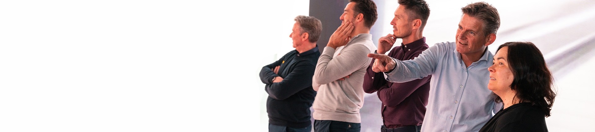 Five people watching a presentation