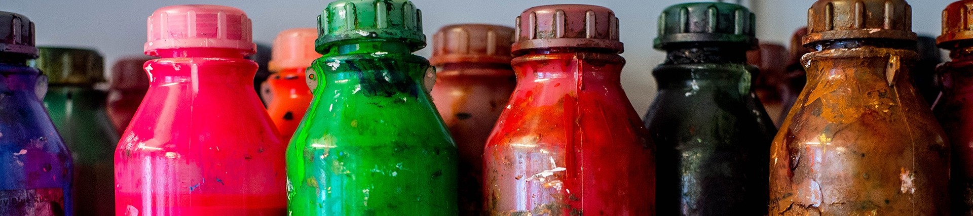 Bottles of paint or ink in a variety of strong colours.