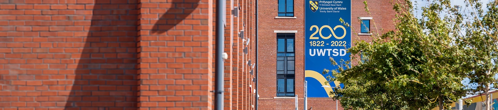 Branded 200 years banner on the side of the IQ building in Swansea