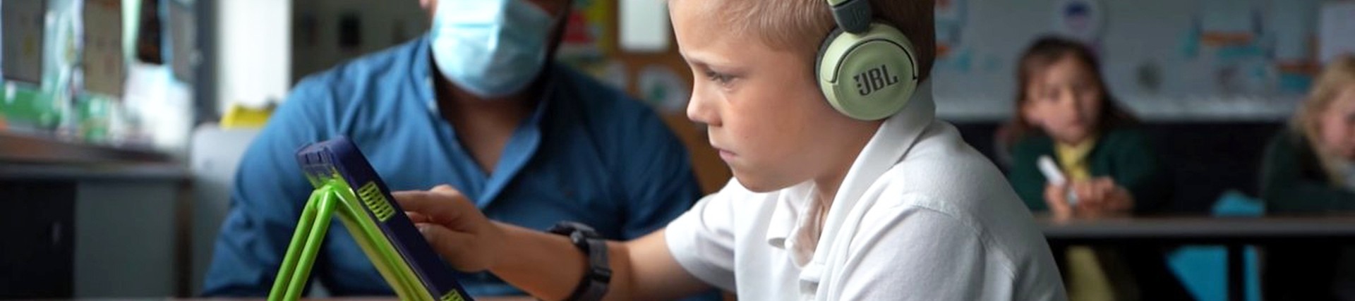Child using Ipad being observed by researcher