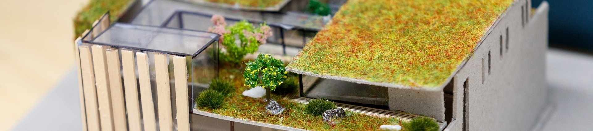 A 1:200 scale model of a building with a roof garden and timber cladding.