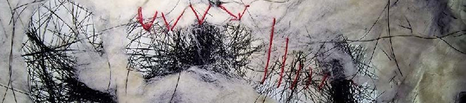 White fleece mixed with a tangle of dark threads; a single red thread has been stitched loosely through the tangle. 