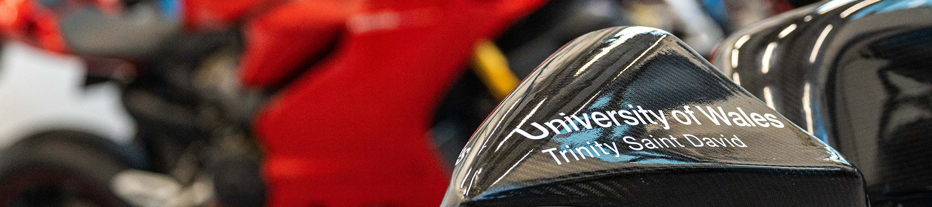 Part of the UWTSD-branded fairing of a racing motorbike.
