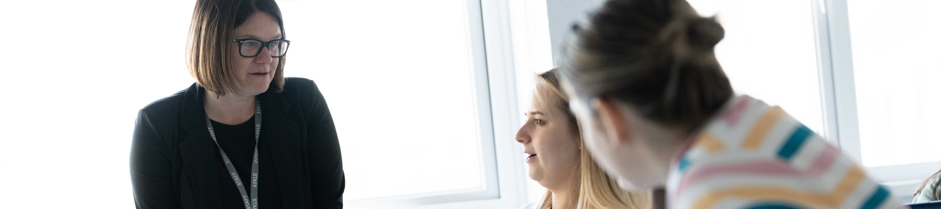 Images of lecturer talking to students in a classroom