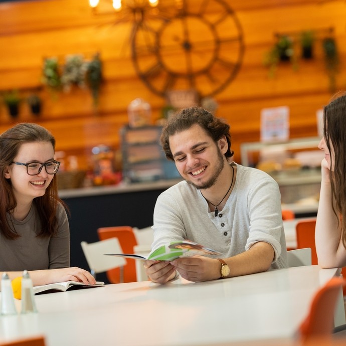 Three students inside café at Carmarthen campus 