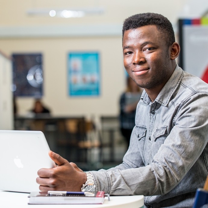 Student sitting down on his laptop