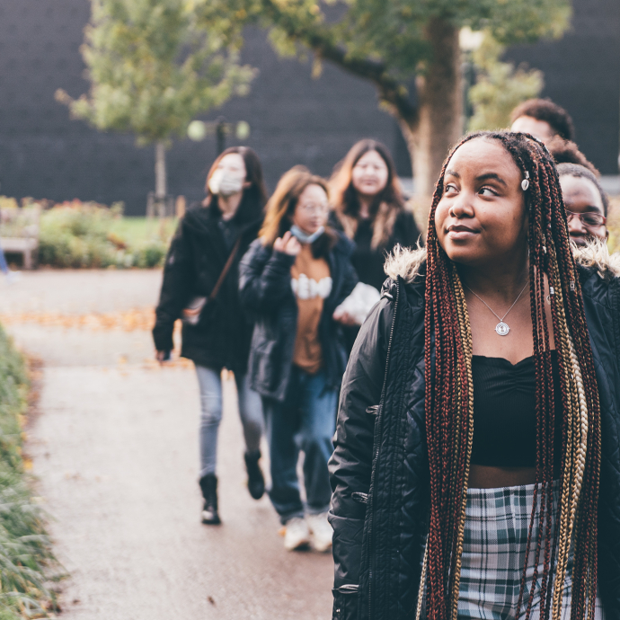 Row of students walking on a path