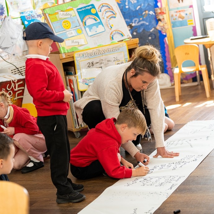 Primary teacher helping young student