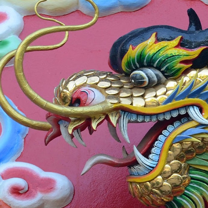A painted carving of a Chinese dragon with gilt scales. 