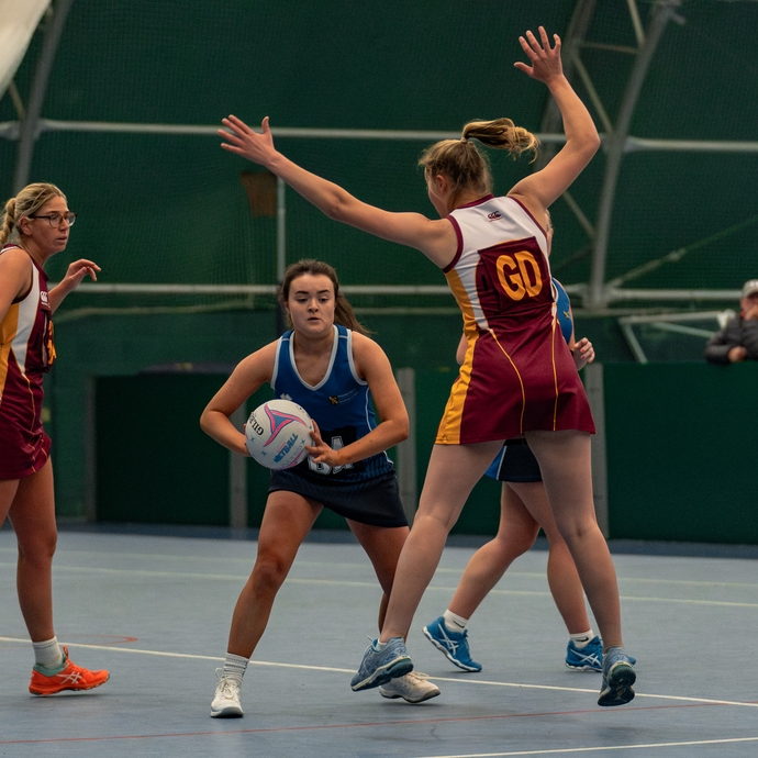 Female students playing netball 