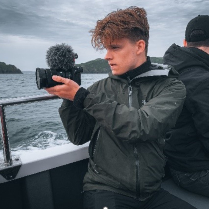 josh on a boat taking photos