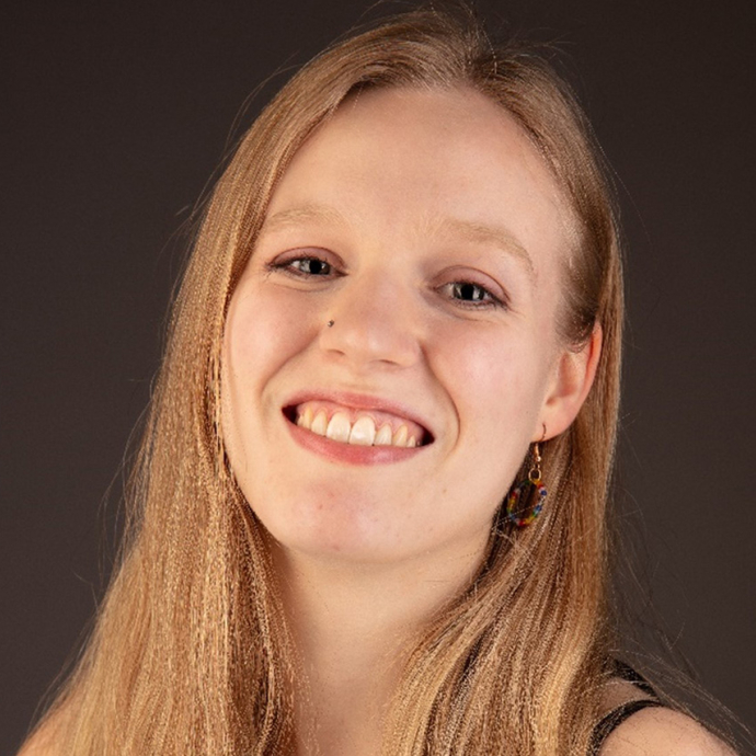 Jojo Bishop smiles for the camera in a studio photo. 