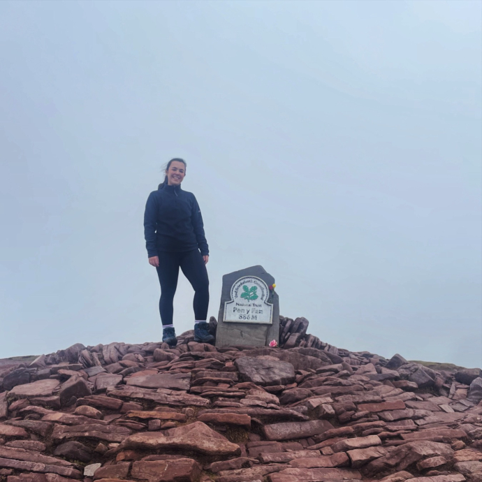 Natalie standing at the top of pen y fan